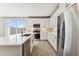 Modern kitchen with white cabinets, stainless steel appliances, island and natural light at 21056 N 58Th St, Phoenix, AZ 85054