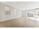 Bright living room featuring tile floors, white walls, recessed lighting, and a sliding glass door at 21056 N 58Th St, Phoenix, AZ 85054