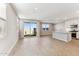 Bright open-concept living space featuring wood-look flooring, recessed lighting, and a sliding glass door to the backyard at 21074 N 58Th St, Phoenix, AZ 85054