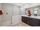 Bathroom boasts double vanity, glass shower, decorative accents, and modern fixtures at 21112 N 58Th St, Phoenix, AZ 85054