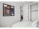 Cozy bedroom view showcasing a mirror reflecting the bed and artwork, with a closet and doorway at 21112 N 58Th St, Phoenix, AZ 85054