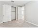 Neutral bedroom featuring neutral carpet, white walls and trim, and closet with sliding doors at 21122 N 58Th St, Phoenix, AZ 85054