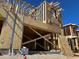 New construction of a modern home showing the wood frame and clear blue skies at 21122 N 58Th St, Phoenix, AZ 85054