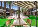 Outdoor area featuring palm trees, a fountain, and inviting seating under striped umbrellas at 21122 N 58Th St, Phoenix, AZ 85054