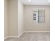 Bedroom featuring neutral walls, neutral carpet, white baseboards, and a window at 21126 N 58Th St, Phoenix, AZ 85054