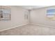 Bright bedroom with neutral carpet, three windows, and neutral colored walls at 21126 N 58Th St, Phoenix, AZ 85054