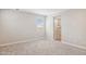 View of bedroom with neutral walls and carpet leading into bathroom with tile shower at 21126 N 58Th St, Phoenix, AZ 85054