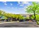 Well-maintained parking lot with lush green trees and convenient access to retail stores at 21126 N 58Th St, Phoenix, AZ 85054