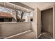 Enclosed balcony with a view of surrounding buildings and trees, featuring access to a storage closet at 234 N 75Th St # 209, Mesa, AZ 85207