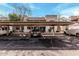 Community covered parking area with designated parking spots and visible nearby residential buildings at 234 N 75Th St # 209, Mesa, AZ 85207