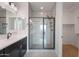 Modern bathroom featuring white countertop vanity, a walk-in closet and a glass-enclosed shower at 24267 W Gibson Ln, Buckeye, AZ 85326