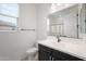 Bright bathroom with white tile, modern vanity, black fixtures, and a mirror at 24267 W Gibson Ln, Buckeye, AZ 85326