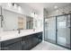 Modern bathroom featuring double sinks, sleek countertops, and a glass-enclosed shower at 24267 W Gibson Ln, Buckeye, AZ 85326