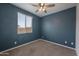 Cozy bedroom featuring a ceiling fan, carpeted floor and a window for natural light at 24267 W Gibson Ln, Buckeye, AZ 85326