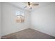 Bedroom featuring a ceiling fan, carpeted floor, a window and neutral paint at 24267 W Gibson Ln, Buckeye, AZ 85326