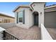 Inviting home facade with gray siding, shutters, brick-paved entrance and desert landscaping at 24267 W Gibson Ln, Buckeye, AZ 85326