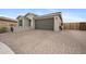 Beautiful home with a brick driveway and desert landscaping, showcasing its curb appeal at 24267 W Gibson Ln, Buckeye, AZ 85326