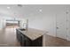 Kitchen island with dark cabinets, granite countertop, and a view of the large sliding doors at 24267 W Gibson Ln, Buckeye, AZ 85326