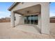 Covered back patio with ceiling fan, tan stucco columns, and desert landscaping at 24267 W Gibson Ln, Buckeye, AZ 85326