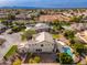 Gorgeous aerial view of the property showcasing the backyard pool and lush landscaping in a desirable neighborhood at 2448 E Amber Ct, Gilbert, AZ 85296