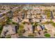 This aerial view showcases lush landscaping and a tranquil pool, nestled in a lovely residential neighborhood at 2448 E Amber Ct, Gilbert, AZ 85296