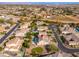 Stunning aerial view of a home, featuring a swimming pool, lush backyard landscaping and neighborhood amenities at 2448 E Amber Ct, Gilbert, AZ 85296