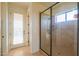 Bright bathroom featuring a glass shower and door leading to a balcony at 2448 E Amber Ct, Gilbert, AZ 85296