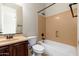 Standard bathroom featuring a tub shower combo, toilet, and vanity with a dark wood finish at 2448 E Amber Ct, Gilbert, AZ 85296