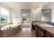 Bright bathroom with a soaking tub, vanity, and natural light pouring in, creating a spa-like experience at 2448 E Amber Ct, Gilbert, AZ 85296