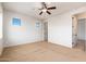 Empty bedroom with carpet, ceiling fan, and windows at 2448 E Amber Ct, Gilbert, AZ 85296