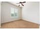 Neutral bedroom with carpeted flooring and large window with shutter at 2448 E Amber Ct, Gilbert, AZ 85296