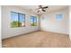 Spacious, carpeted bedroom with natural light from large windows at 2448 E Amber Ct, Gilbert, AZ 85296