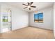 Empty bedroom featuring a window, ceiling fan, and neutral carpet at 2448 E Amber Ct, Gilbert, AZ 85296