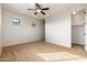 Carpeted bedroom features neutral walls, ceiling fan and natural light at 2448 E Amber Ct, Gilbert, AZ 85296