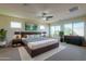 Comfortable bedroom featuring a king bed, soft rug, and large windows providing plenty of natural light at 2448 E Amber Ct, Gilbert, AZ 85296