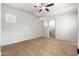 A secondary bedroom features neutral walls, carpeted floor, a ceiling fan and access to an en-suite bathroom at 2448 E Amber Ct, Gilbert, AZ 85296