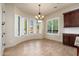 Bright dining area with a chandelier, bay windows with shutter and wood flooring at 2448 E Amber Ct, Gilbert, AZ 85296