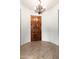 Foyer features an ornate chandelier, hardwood floors, and a striking wooden front door at 2448 E Amber Ct, Gilbert, AZ 85296