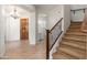 Open foyer showcases stairs, the front door, a chandelier, and a view into a bathroom at 2448 E Amber Ct, Gilbert, AZ 85296