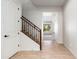 Foyer view features tile flooring, stairs with wrought iron accents, and a glimpse into the living area at 2448 E Amber Ct, Gilbert, AZ 85296