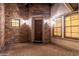 Charming covered entry featuring stone accents, warm lighting, and a wooden front door at 2448 E Amber Ct, Gilbert, AZ 85296