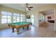 Spacious game room featuring a billiards table, tile floors, a ceiling fan, and ample light at 2448 E Amber Ct, Gilbert, AZ 85296