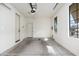 An empty two car garage featuring concrete floors, white walls, and natural light at 2448 E Amber Ct, Gilbert, AZ 85296