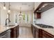 Kitchen area with granite countertops, stainless appliances, and natural light at 2448 E Amber Ct, Gilbert, AZ 85296