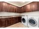 Functional laundry room features ample cabinets, counter space and a washer and dryer at 2448 E Amber Ct, Gilbert, AZ 85296