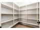 A walk-in pantry with many shelves and wood-look flooring provides ample storage space at 2448 E Amber Ct, Gilbert, AZ 85296