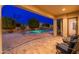 Evening view of the covered patio that overlooks the pool and backyard at 2448 E Amber Ct, Gilbert, AZ 85296