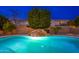 Swimming pool with rock waterfall and plenty of space for backyard fun at 2448 E Amber Ct, Gilbert, AZ 85296