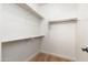 A walk-in closet features white walls, carpeted floor, and metal shelving at 2448 E Amber Ct, Gilbert, AZ 85296