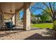 Covered patio with brick pavers leads to a backyard oasis with lush landscaping at 2467 E Page Ave, Gilbert, AZ 85234